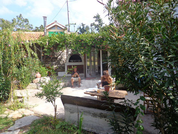 Vor dem Steinhaus befindet sich ein traditioneller Backoffen und rechts daneben die Außenkücke